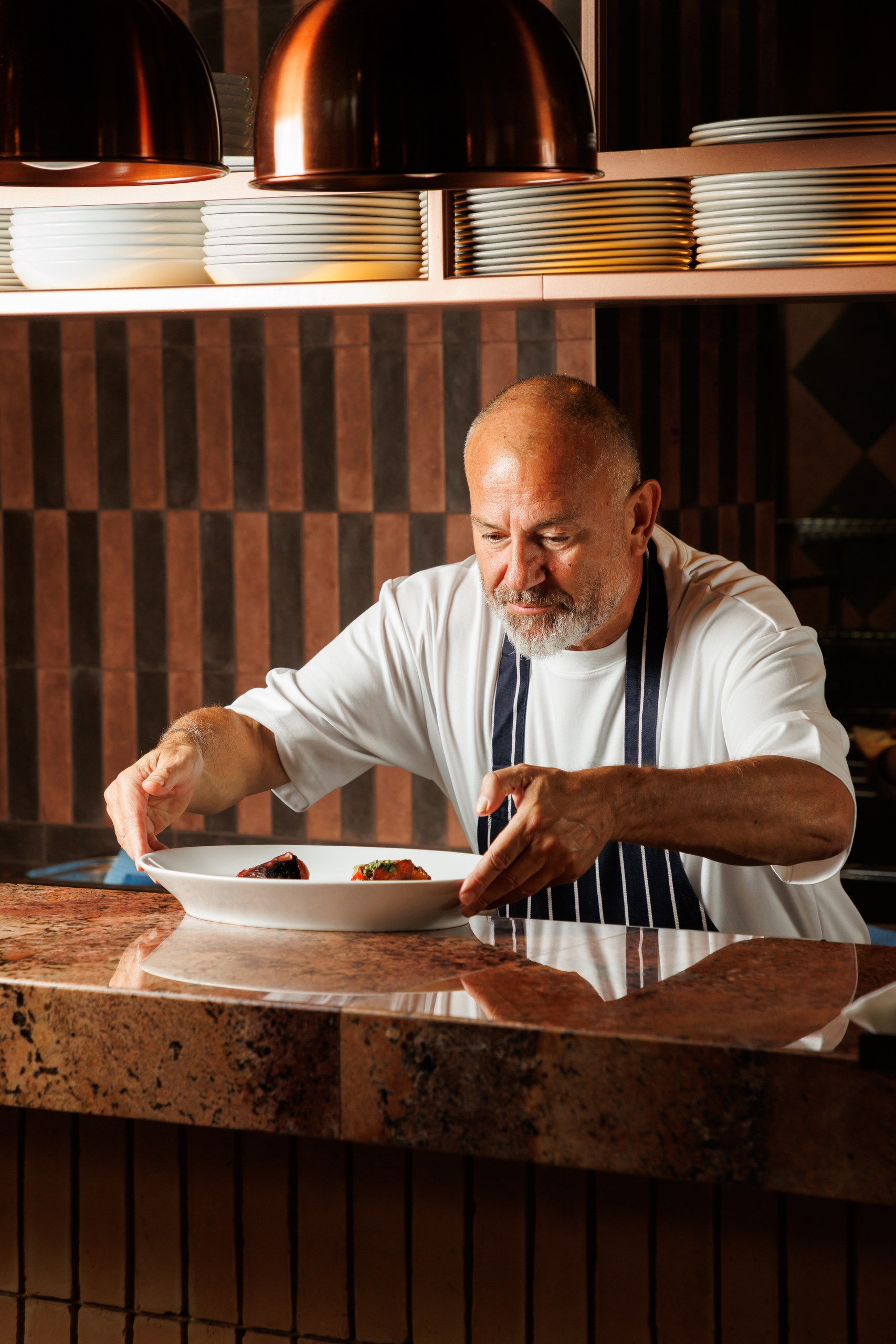 Executive chef Glen Ballis plating a dish at the pass
