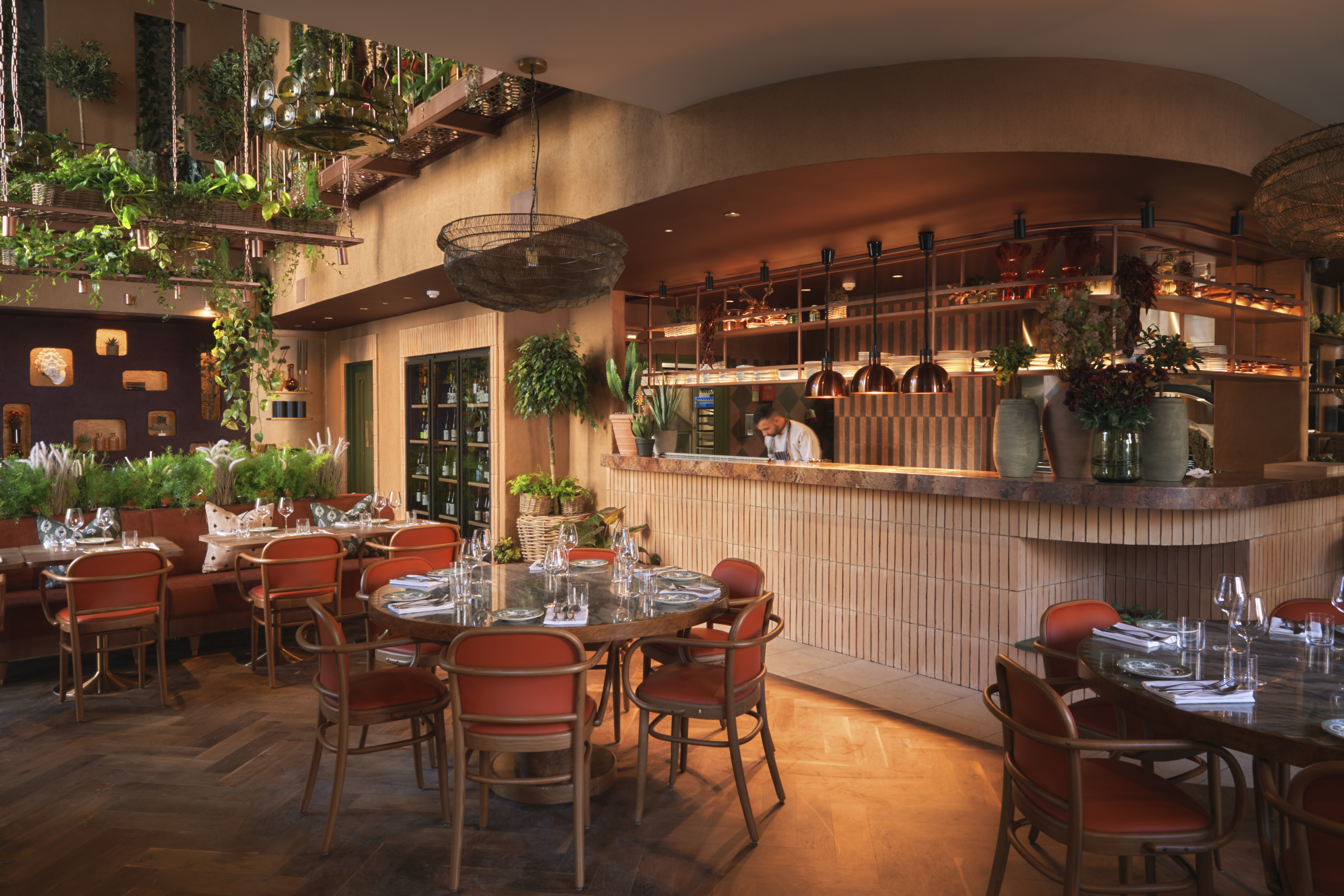 The bar at Clio with wine glasses set on marble tables