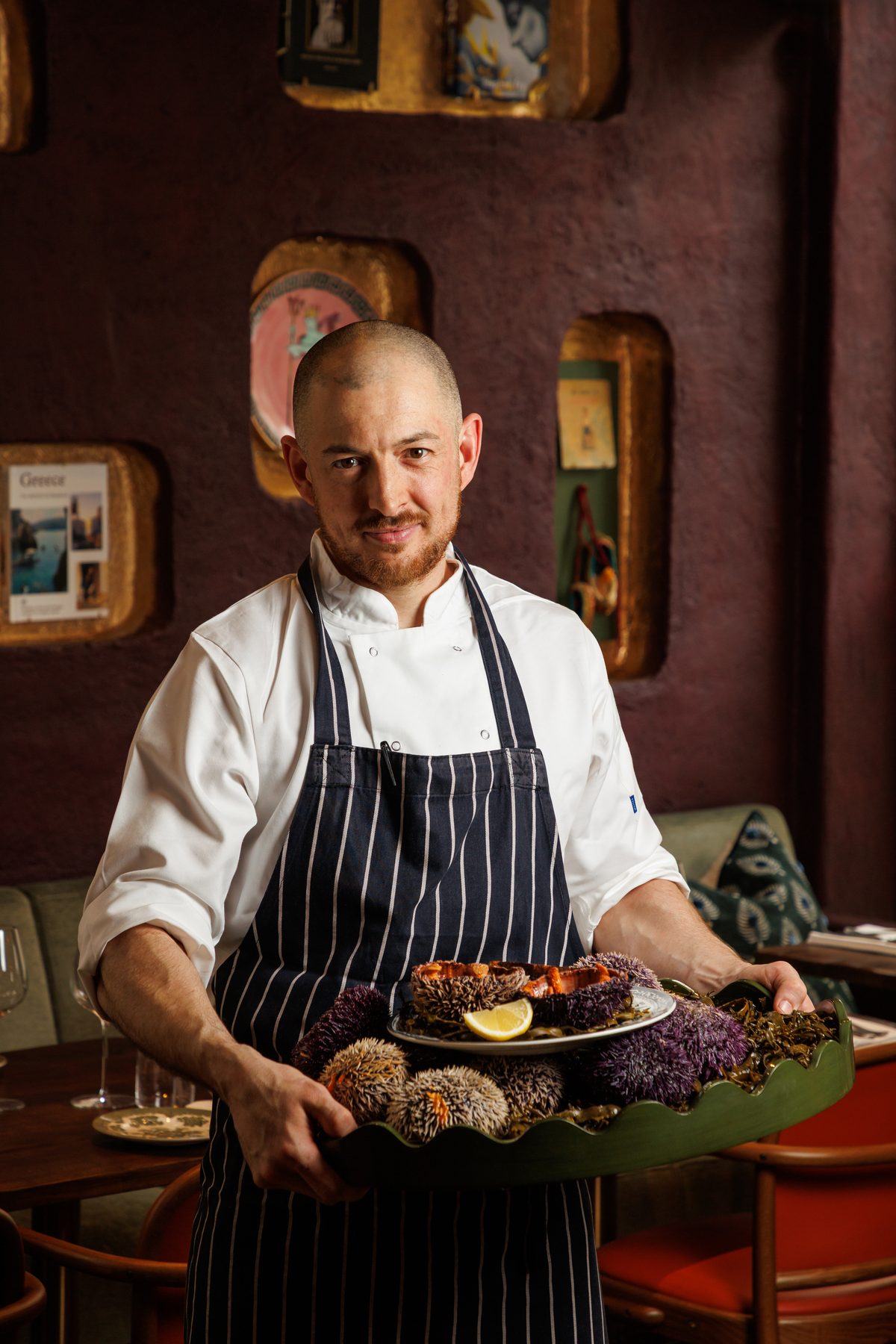 Head chef Louis Korovias holding a tray of fresh sea urchins