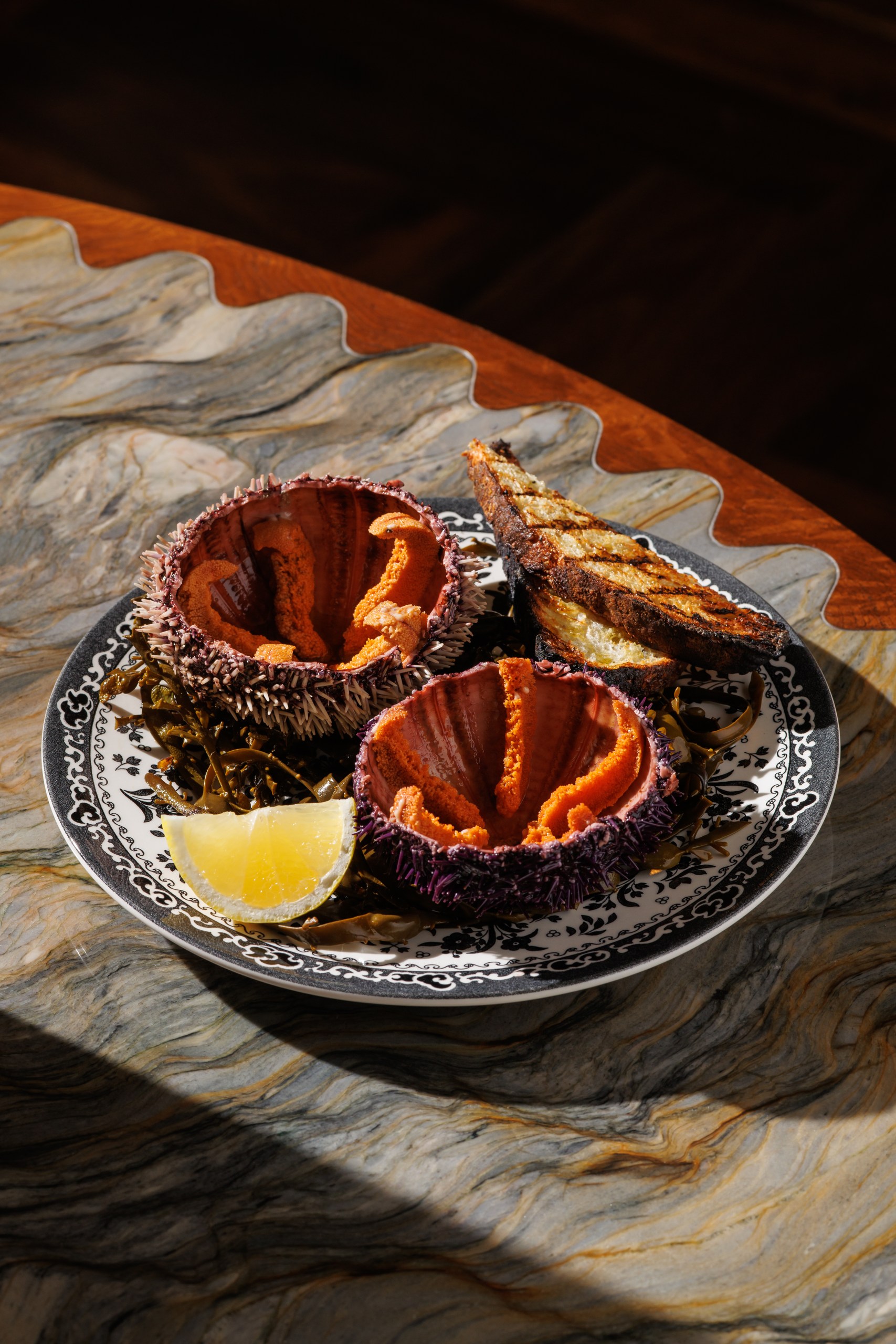 Fresh sea urchin served with grilled bread and lemon